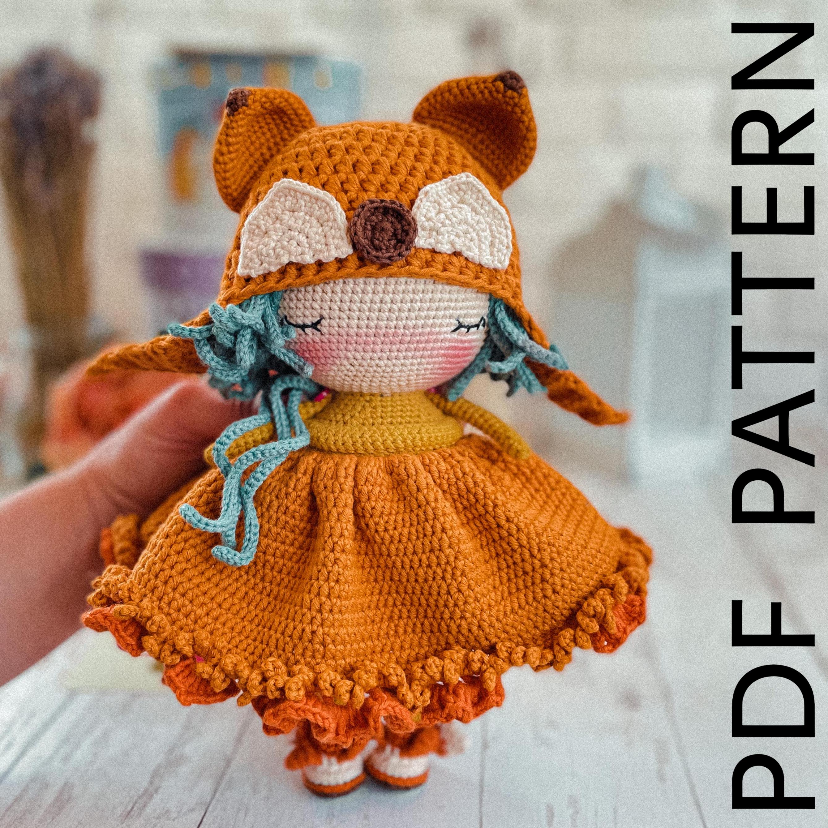 a small crocheted doll in a dress